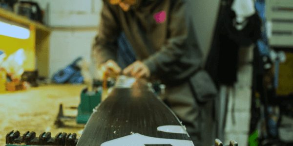 Skier Tuning A Ski On A Workbench